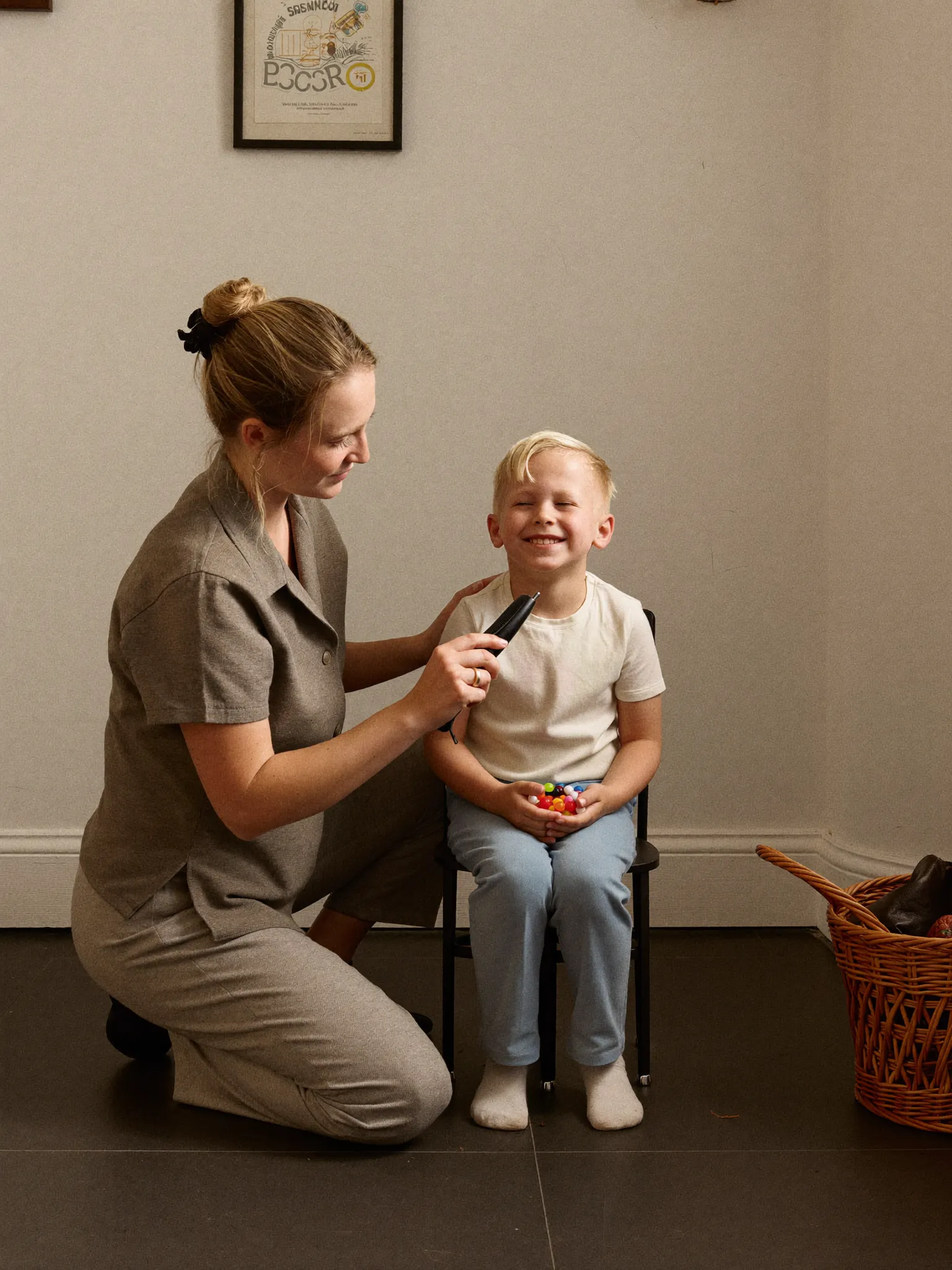 Gentle sensory-safe haircut for a smiling young boy