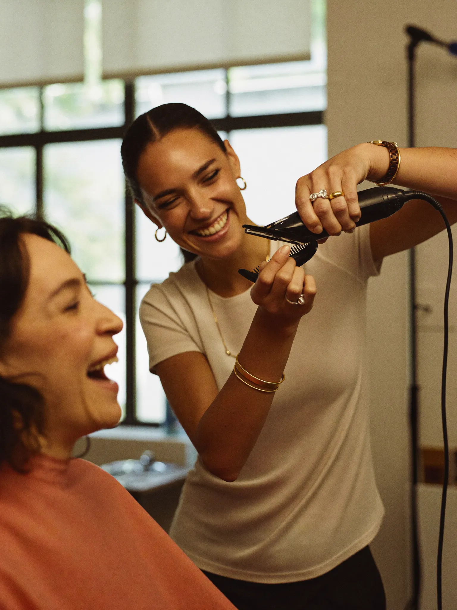 Stylist giving a woman a haircut at Kate's Kuts